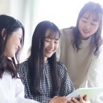 タブレットを見ながら話し合いをする学生たち